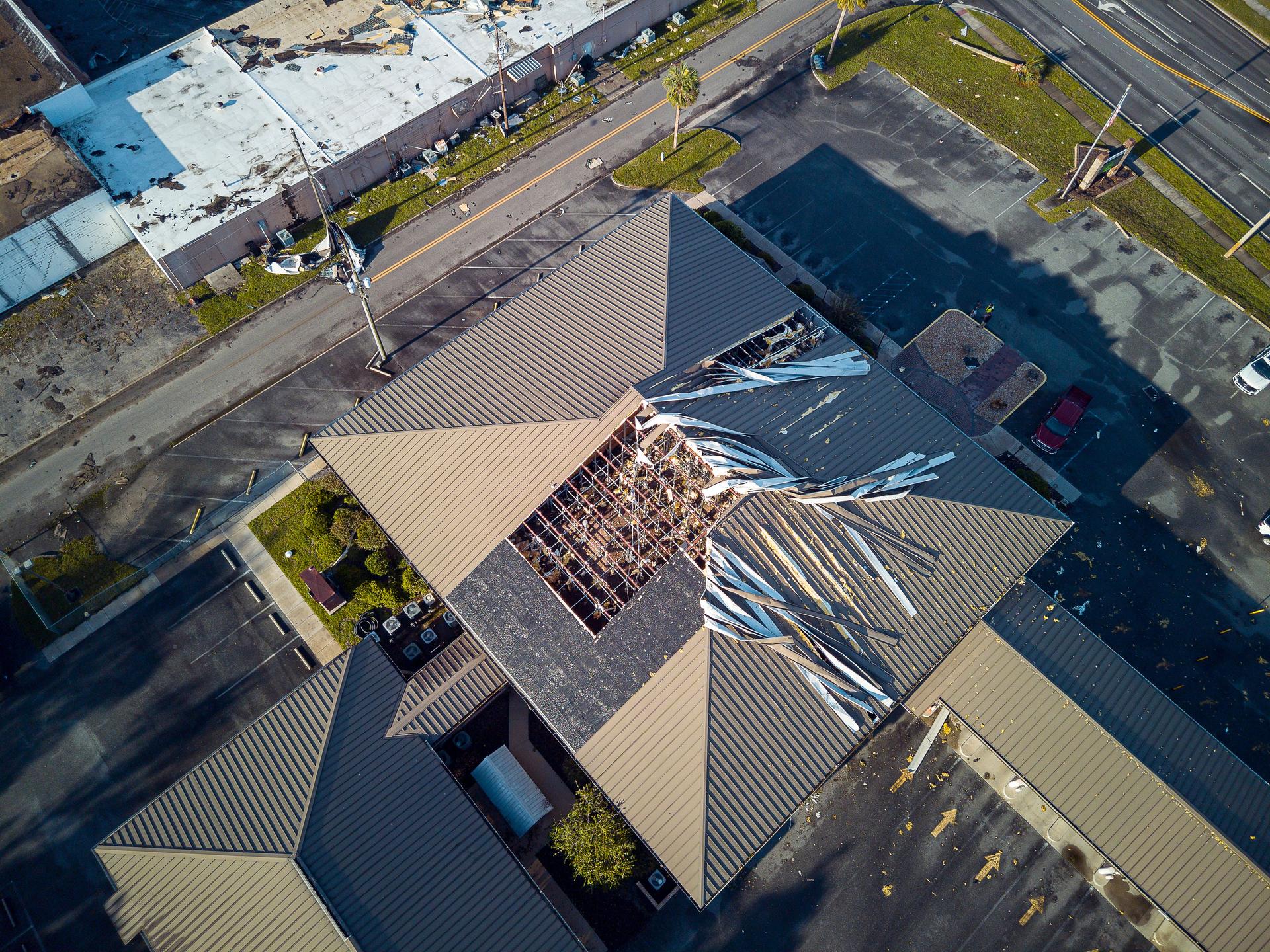 Hurricane hit public buildings in Perry, FL: public building roof twisted after storm. North Florida hurricane aftermath. Top view