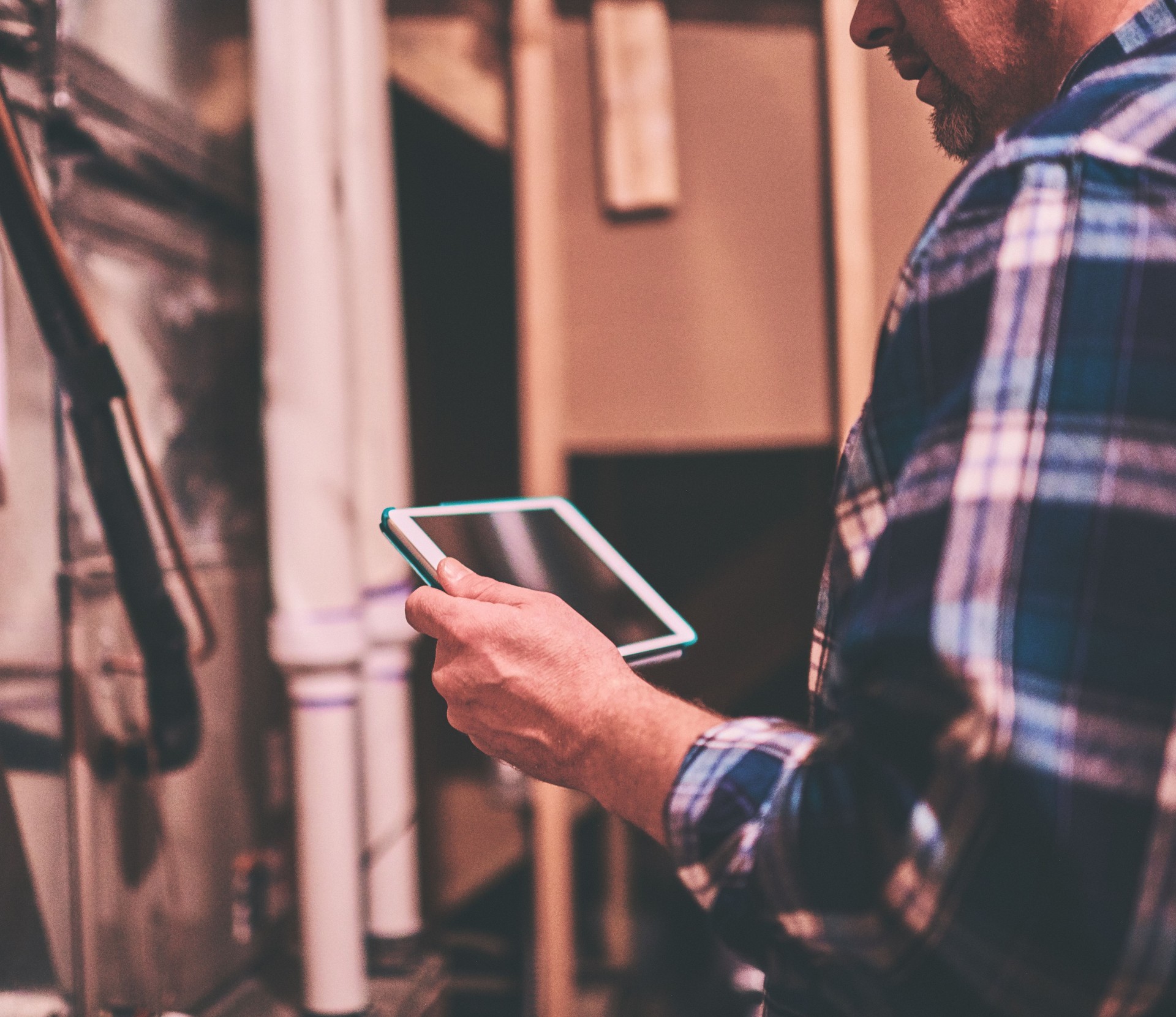 Home Appraiser or Home Inspector using digital tablet in furnace room