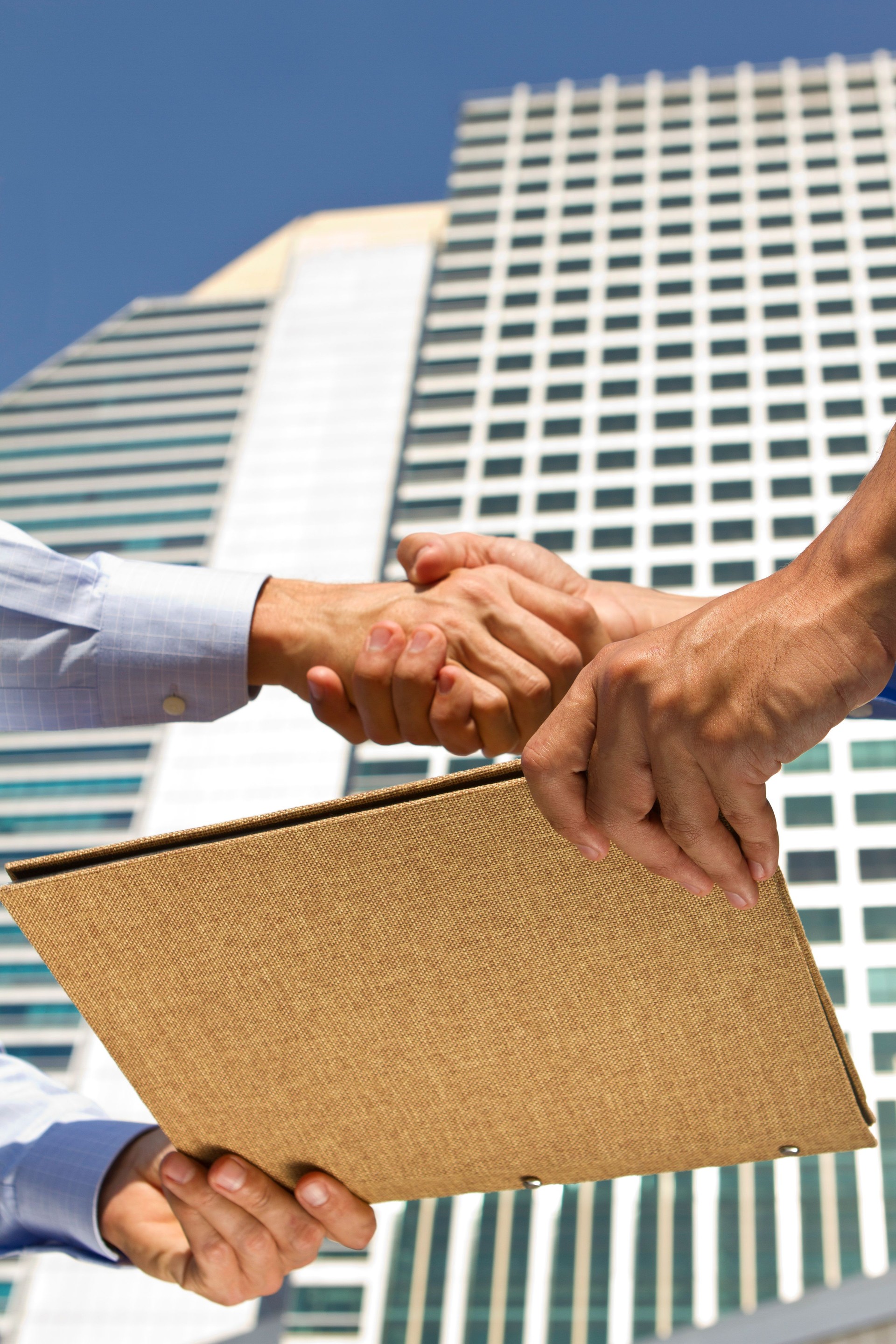 Business deal with a file report in a financial district